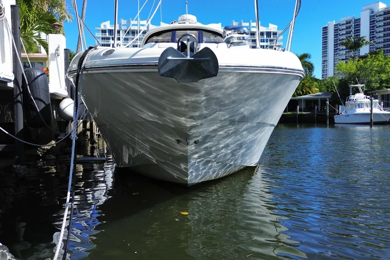 Slide: The Image of 2008 Sea Ray Sundancer 330 docked in a marina with cityscape background. - 11