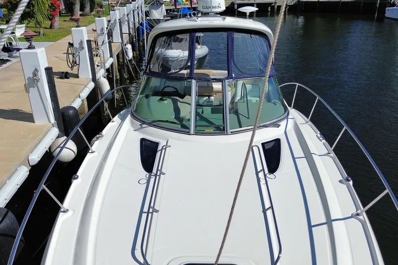 Slide: The Image of 2008 Sea Ray Sundancer 330 docked at marina, showcasing sleek design and spacious deck. - 12