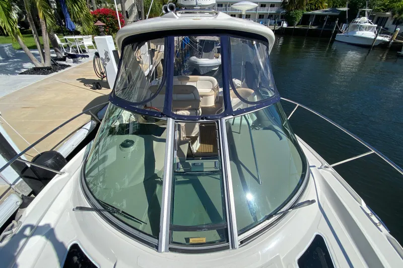 Slide: The Image of 2008 Sea Ray Sundancer 330 docked, showcasing sleek design and spacious cockpit. - 18