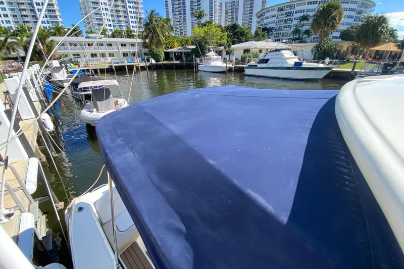 Slide: The Image of 2008 Sea Ray Sundancer 330 docked in a marina with surrounding boats and buildings. - 20