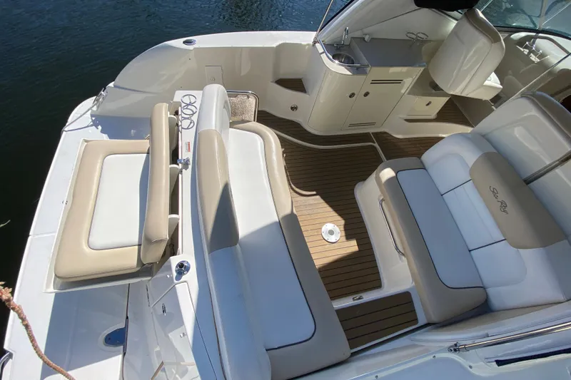 Slide: The Image of 2008 Sea Ray Sundancer 330 boat interior with beige seating and wood flooring. - 21