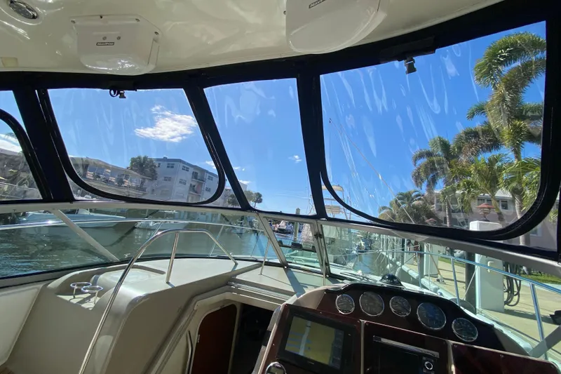 Slide: The Image of 2008 Sea Ray Sundancer 330 cockpit view with marina and palm trees in background. - 35