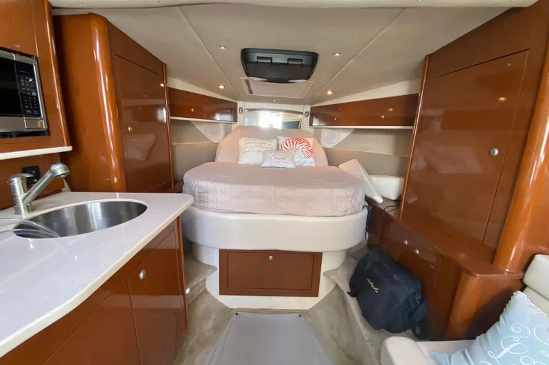 Slide: The Image of 2008 Sea Ray Sundancer 330 cabin interior with bed, sink, and wooden cabinetry. - 41