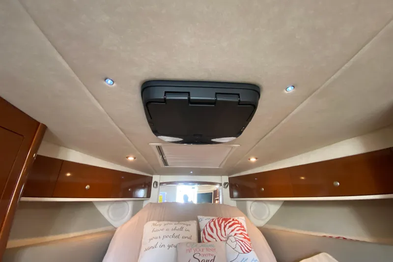 Slide: The Image of Interior cabin of 2008 Sea Ray Sundancer 330 with cozy bedding and wooden accents. - 44