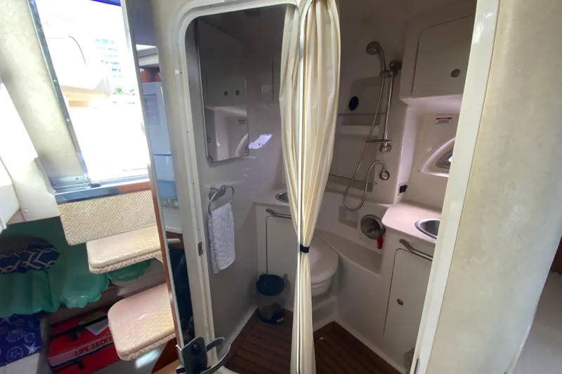 Slide: The Image of 2008 Sea Ray Sundancer 330 bathroom with shower, sink, and toilet, featuring compact design. - 49