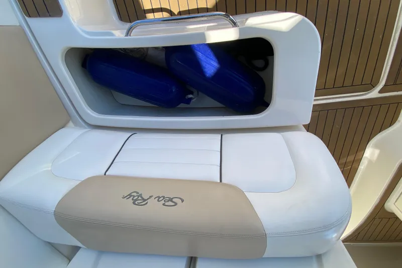 Slide: The Image of 2008 Sea Ray Sundancer 330 boat seat with storage compartment and blue fenders. - 56