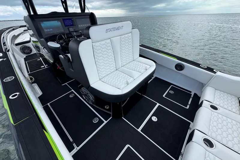 Slide: The Image of 2024 Statement 350 Open boat interior with luxurious seating and modern dashboard on open water. - 10