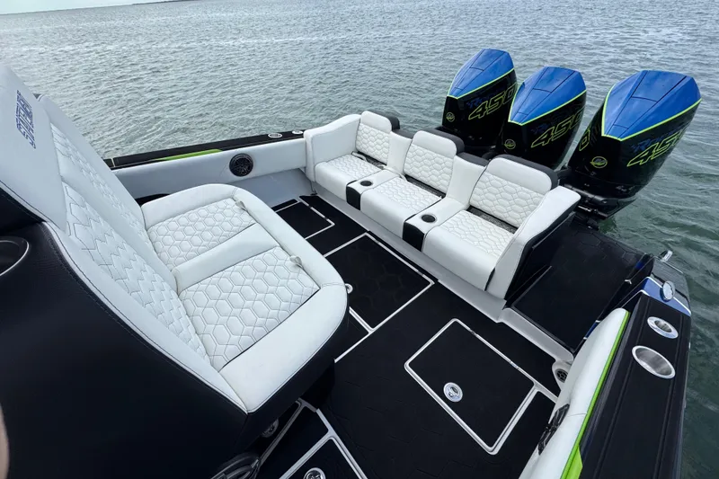 Slide: The Image of 2024 Statement 350 Open boat with luxurious seating and powerful engines on the water. - 13