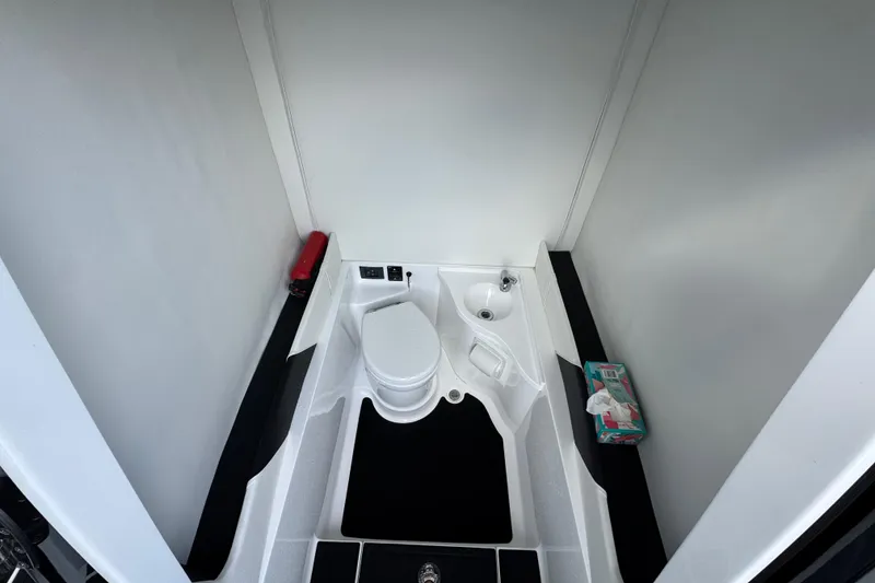 Slide: The Image of 2024 Statement 350 Open boat bathroom with toilet, sink, and storage shelves. - 16