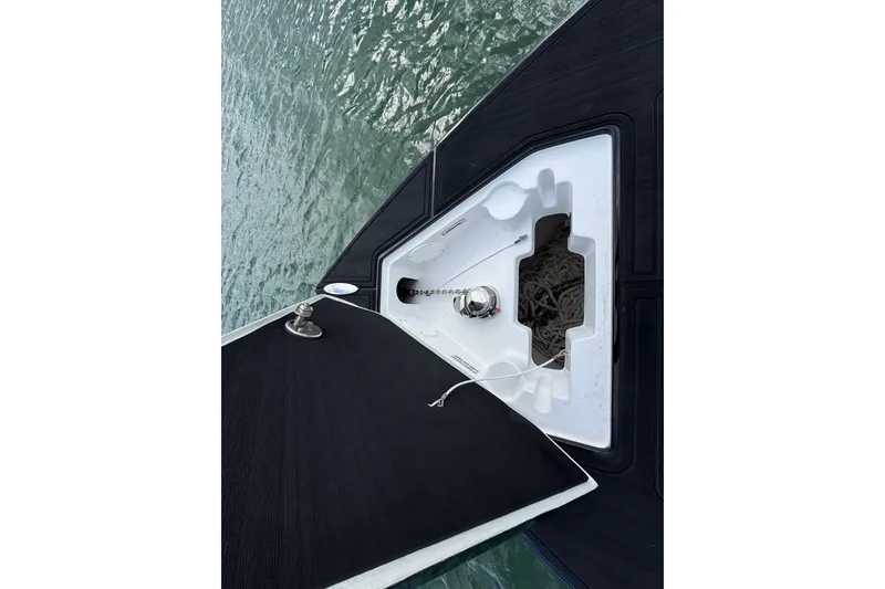 Slide: The Image of 2024 Statement 350 Open boat anchor compartment with rope storage, viewed from above. - 18