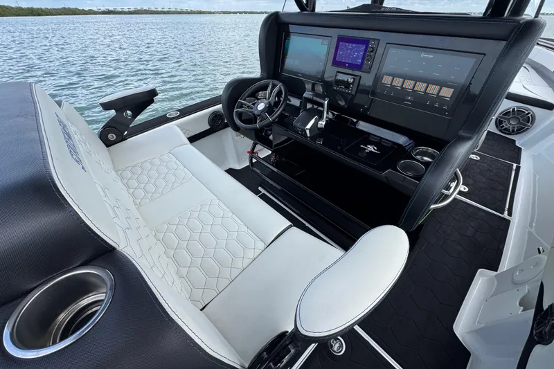 Slide: The Image of 2024 Statement 350 Open boat cockpit with advanced navigation system and luxurious seating. - 9