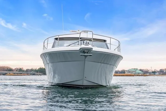 Slide: The Image of 2014 Riviera 4400 Sport Yacht on calm water under a clear blue sky. - 12