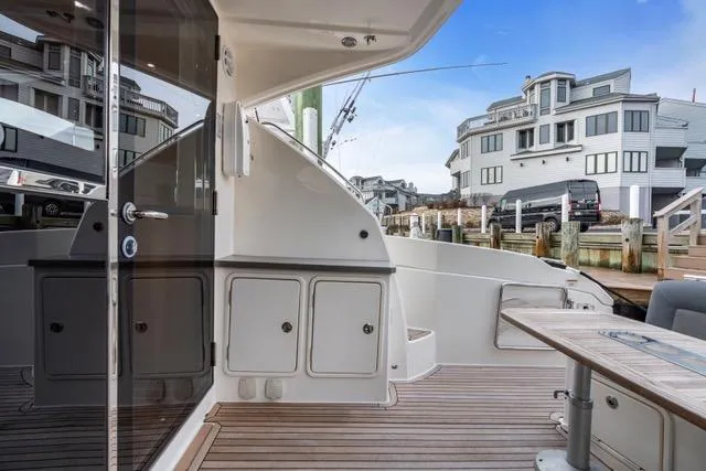 Slide: The Image of 2014 Riviera 4400 Sport Yacht deck with modern design and waterfront view. - 29