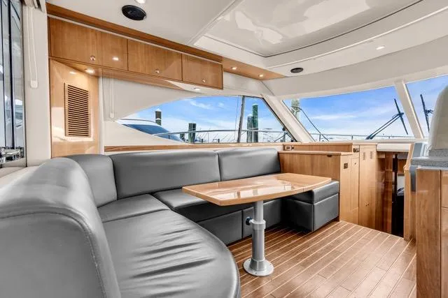 Slide: The Image of Luxurious interior of 2014 Riviera 4400 Sport Yacht with sleek seating and wooden accents. - 39