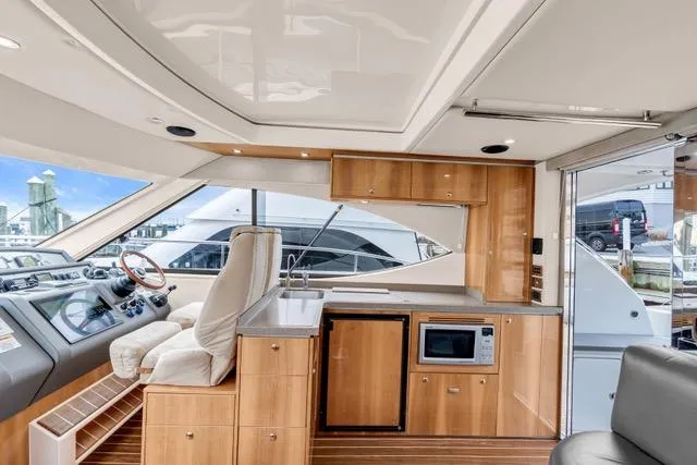 Slide: The Image of Interior of 2014 Riviera 4400 Sport Yacht with modern kitchen and helm station. - 43