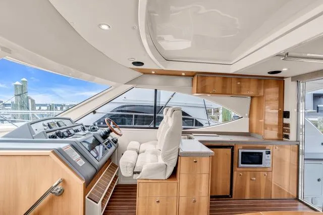 Slide: The Image of Luxurious interior of 2014 Riviera 4400 Sport Yacht with modern helm and kitchen amenities. - 44