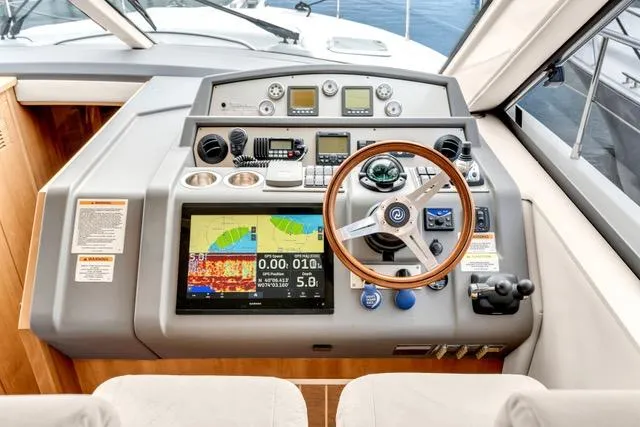 Slide: The Image of 2014 Riviera 4400 Sport Yacht helm with advanced navigation and control systems. - 51