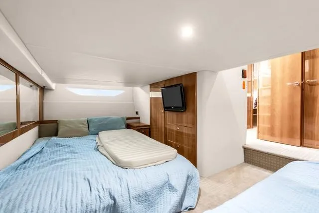 Slide: The Image of Interior of 2014 Riviera 4400 Sport Yacht with cozy bedroom and modern amenities. - 57