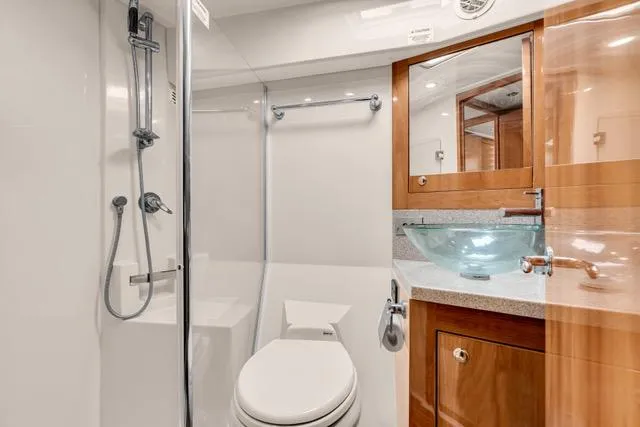 Slide: The Image of Luxurious bathroom in 2014 Riviera 4400 Sport Yacht with modern fixtures and glass sink. - 60