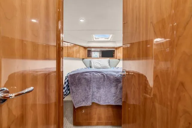 Slide: The Image of Luxurious cabin interior of 2014 Riviera 4400 Sport Yacht with cozy bedding. - 62