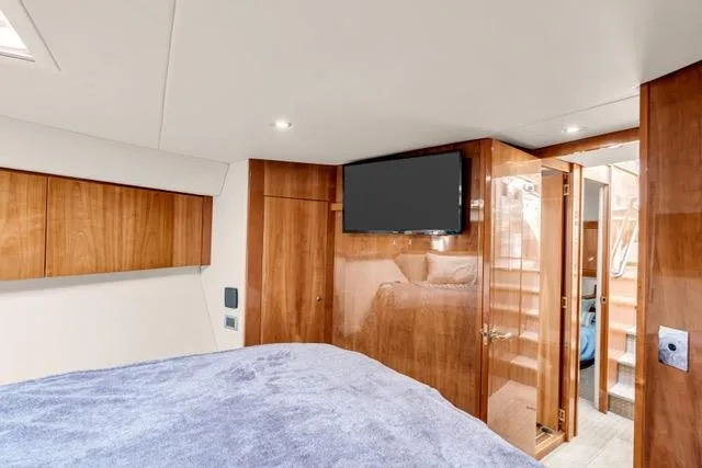 Slide: The Image of Luxurious interior of 2014 Riviera 4400 Sport Yacht with wood paneling and modern amenities. - 64