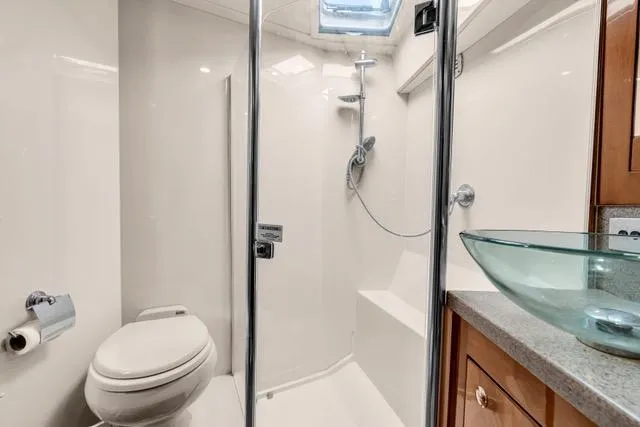 Slide: The Image of Luxurious bathroom in 2014 Riviera 4400 Sport Yacht with glass shower and modern fixtures. - 66
