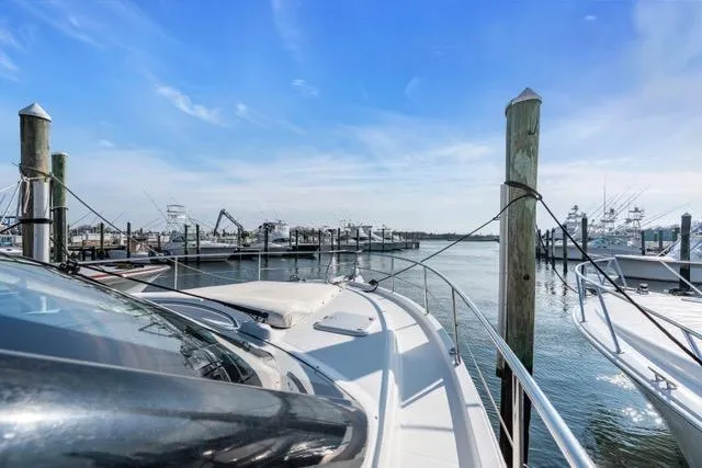 Slide: The Image of 2014 Riviera 4400 Sport Yacht docked at marina under clear blue sky. - 67
