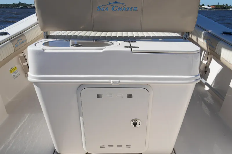 Slide: The Image of 2019 SeaChaser 24 HFC boat interior with storage compartment and seating. - 18
