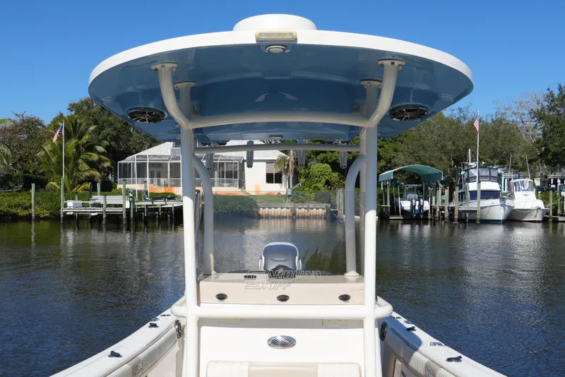 Slide: The Image of 2019 SeaChaser 24 HFC boat docked in a scenic waterfront setting. - 24