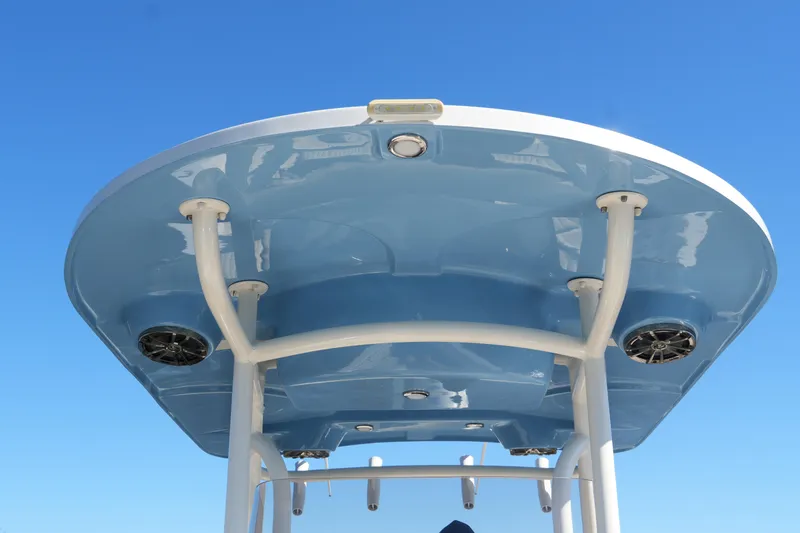 Slide: The Image of 2019 SeaChaser 24 HFC boat T-top against clear blue sky. - 25