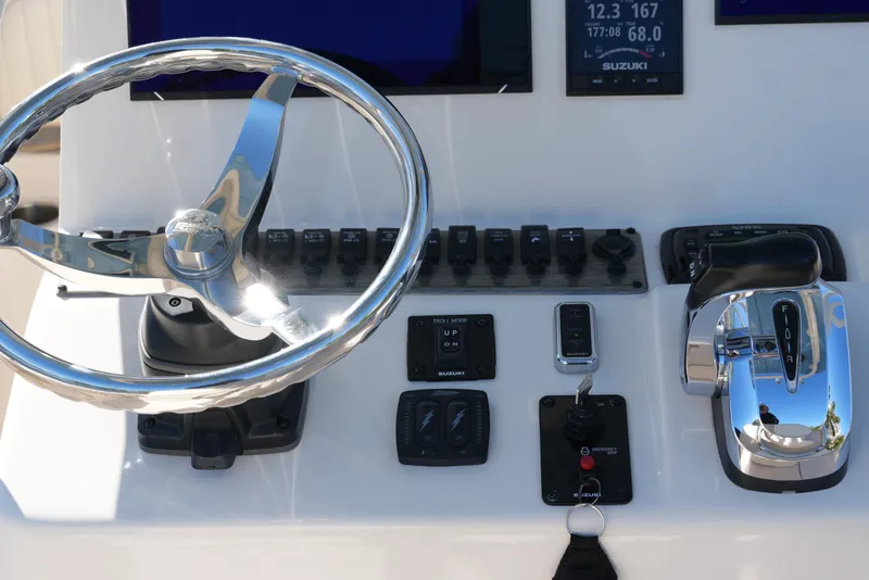 Slide: The Image of 2019 SeaChaser 24 HFC boat dashboard with steering wheel and controls. - 34