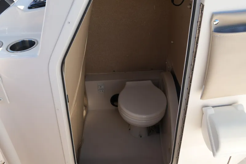 Slide: The Image of 2019 SeaChaser 24 HFC boat interior with compact marine toilet. - 38