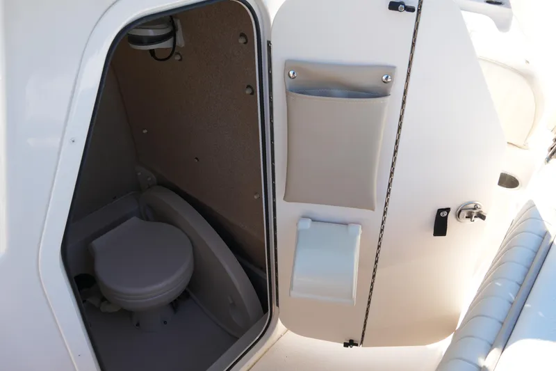 Slide: The Image of 2019 SeaChaser 24 HFC boat interior with compact marine toilet. - 39