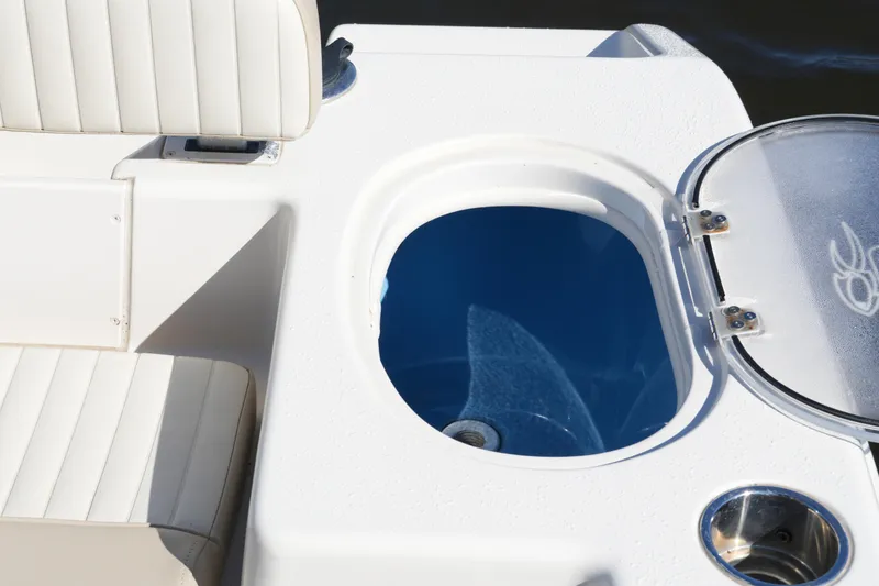Slide: The Image of 2019 SeaChaser 24 HFC boat interior with seating and open storage compartment. - 42