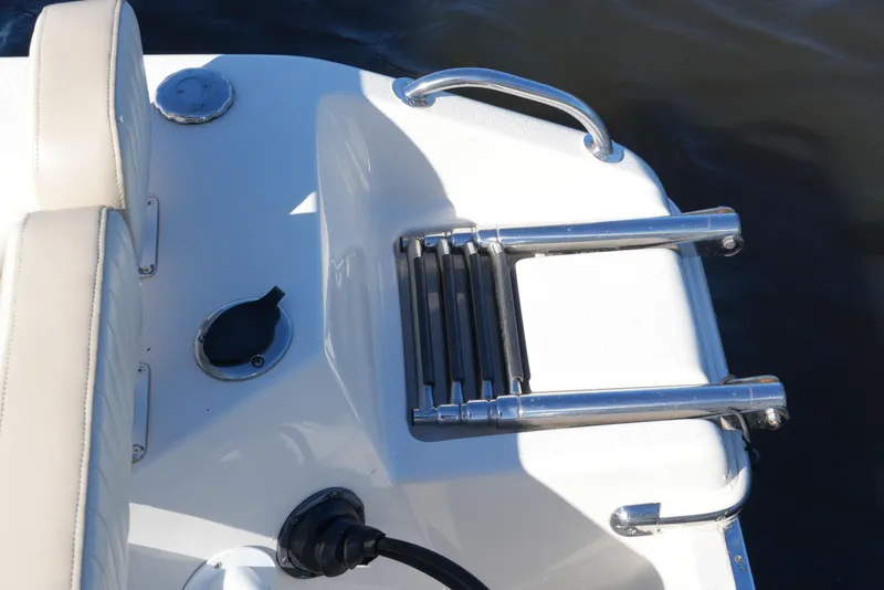 Slide: The Image of 2019 SeaChaser 24 HFC boat with foldable swim ladder and seating. - 43