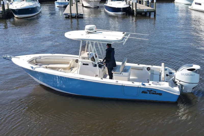 Slide: The Image of 2019 SeaChaser 24 HFC boat with Suzuki engine, docked in a marina. - 5