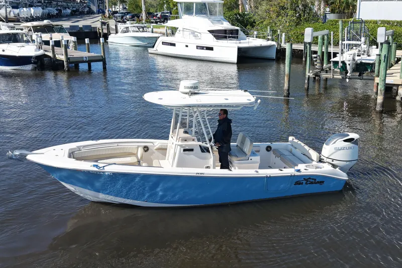 Slide: The Image of 2019 SeaChaser 24 HFC boat with Suzuki engine on calm water near docks. - 6