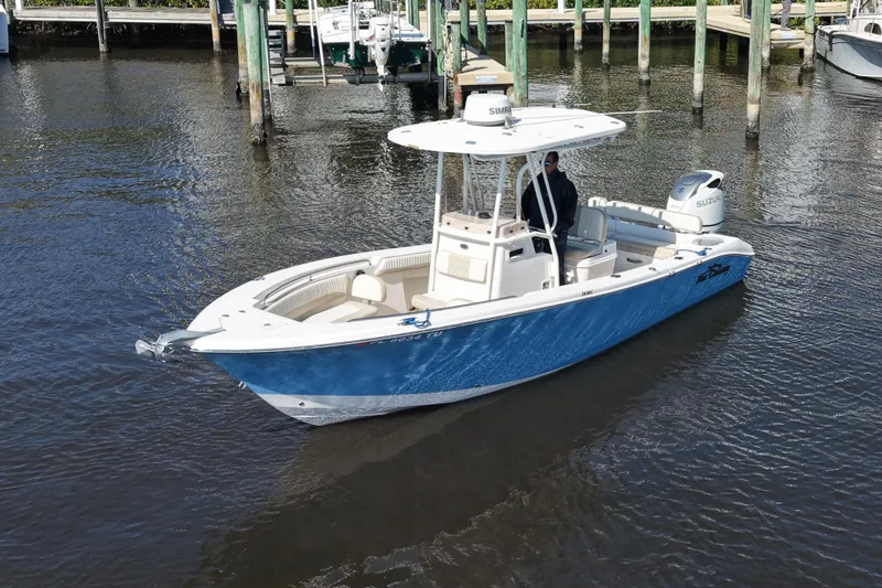 Slide: The Image of 2019 SeaChaser 24 HFC boat in water, featuring blue hull and white interior. - 7