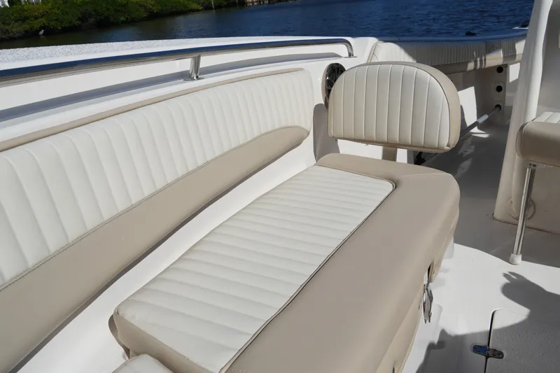 Slide: The Image of 2019 SeaChaser 24 HFC boat interior with beige and white cushioned seating. - 13