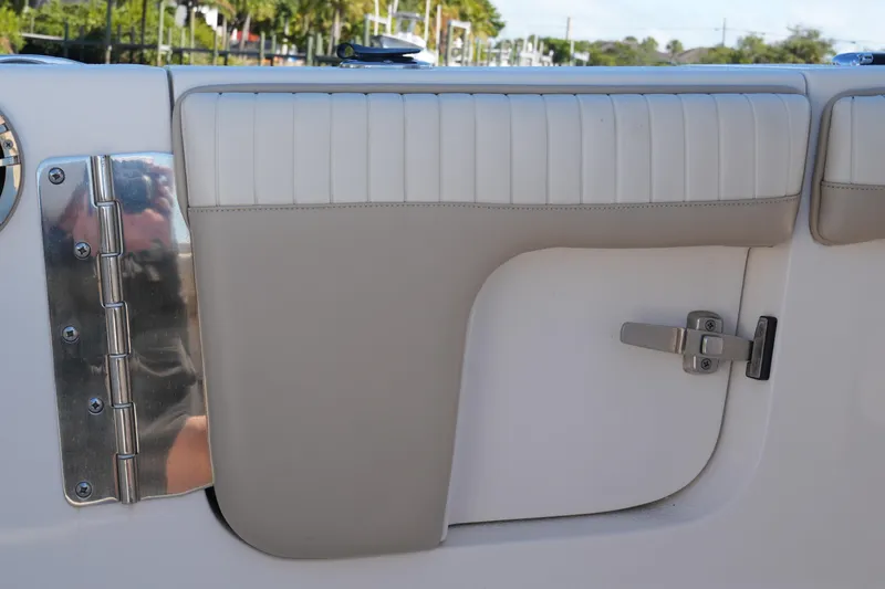 Slide: The Image of 2019 SeaChaser 24 HFC boat interior detail with padded panel and metal latch. - 20