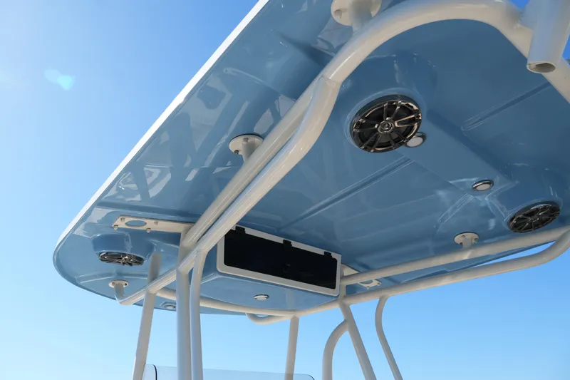 Slide: The Image of 2019 SeaChaser 24 HFC boat T-top with speakers against clear blue sky. - 26