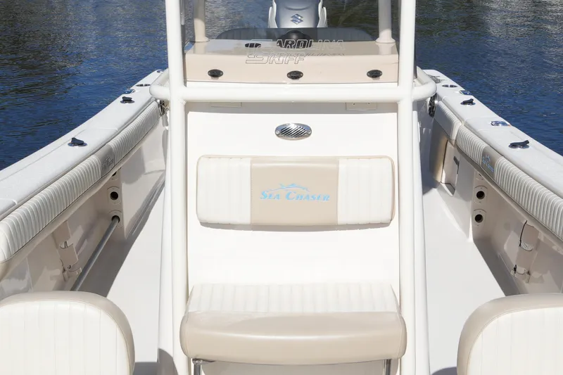 Slide: The Image of 2019 SeaChaser 24 HFC boat interior with seating and console, on calm water. - 27