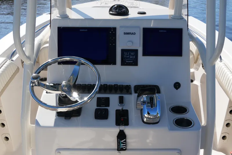Slide: The Image of 2019 SeaChaser 24 HFC boat console with steering wheel and navigation controls. - 31