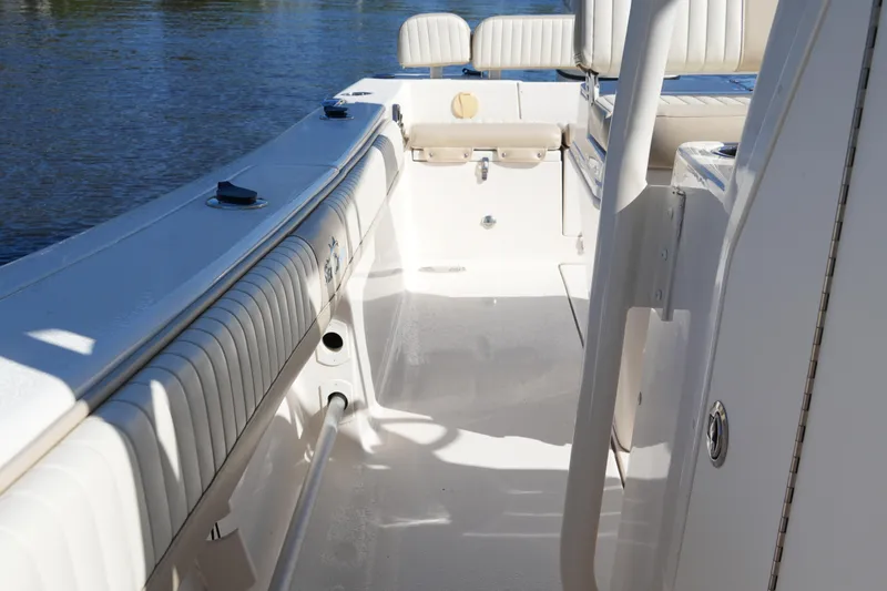 Slide: The Image of 2019 SeaChaser 24 HFC boat interior with cushioned seating and open deck. - 36