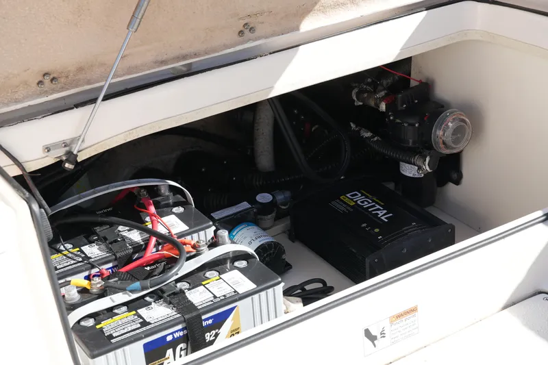 Slide: The Image of 2019 SeaChaser 24 HFC boat battery compartment with digital charger and wiring. - 40