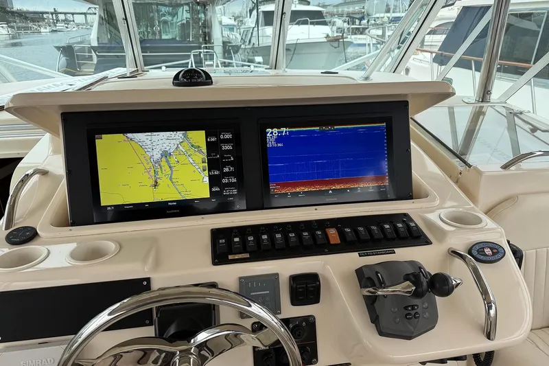Slide: The Image of 2006 Grady-White Express 360 helm with navigation screens and controls. - 11