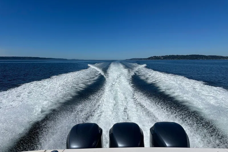 Slide: The Image of 2006 Grady-White Express 360 boat creating wake on open water under clear blue sky. - 13