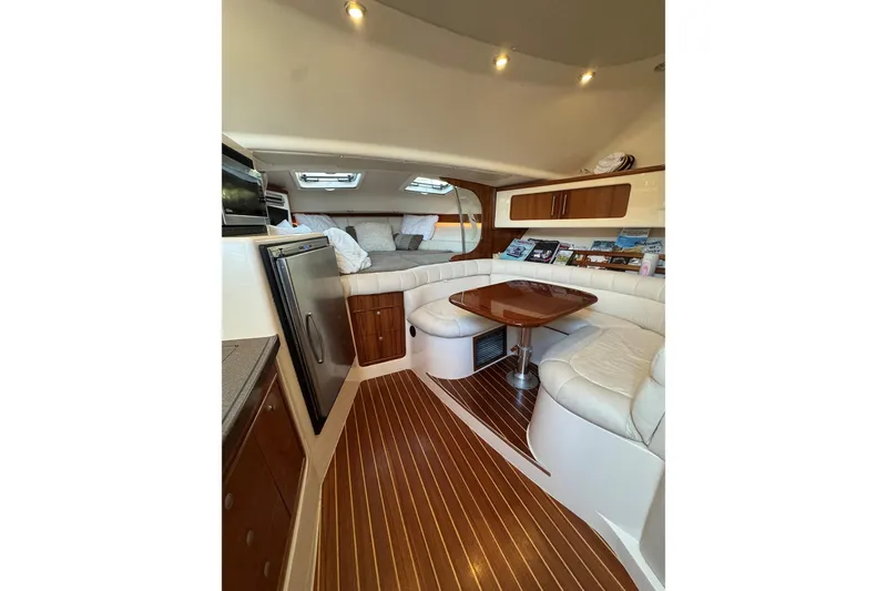 Slide: The Image of Luxurious interior of 2006 Grady-White Express 360 boat with wood accents and seating area. - 14