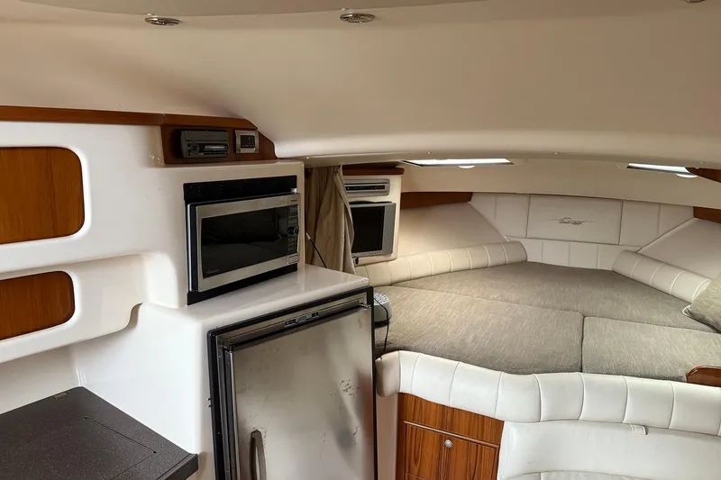 Slide: The Image of 2006 Grady-White Express 360 cabin interior with bed, microwave, and fridge. - 17