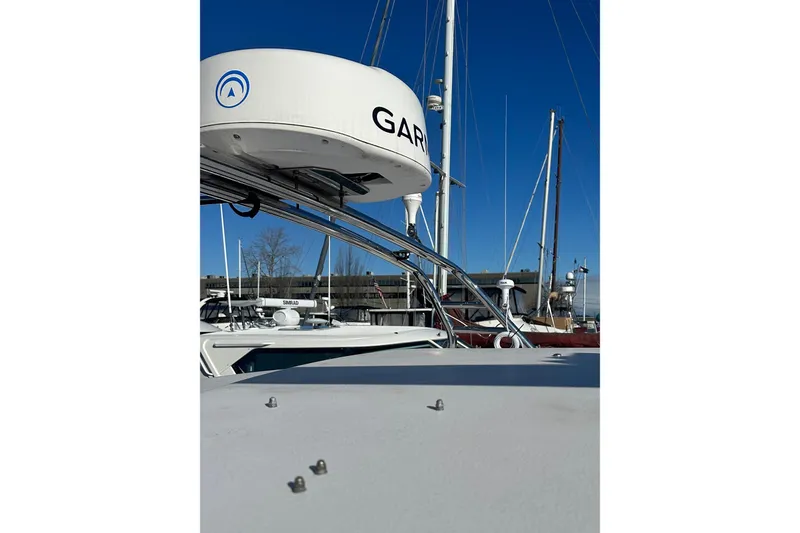 Slide: The Image of 2006 Grady-White Express 360 boat with radar equipment, docked under clear blue sky. - 3